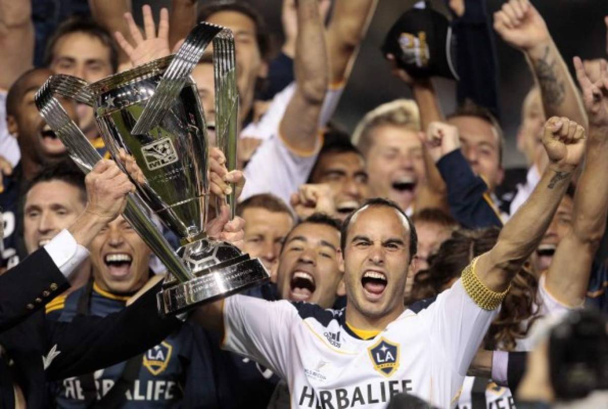 FILE - In this Nov. 20, 2011, file photo, Los Angeles Galaxy forward Landon Donovan holds up the MLS Cup after they defeated the Houston Dynamo 1-0 in Carson, Calif. Donovan appears set to come out of retirement and rejoin the Los Angeles Galaxy The team tweeted 'He's back' on Thursday, Sept. 8, 2016, along with a video of Donovan putting on a No. 26 Galaxy jersey. (AP Photo/Bret Hartman File)