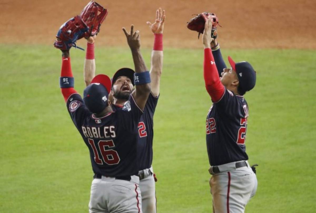 HOUSTON, TEXAS - OCTOBER 22: Juan Soto #22, Victor Robles #16 and Adam Eaton #2 of the Washington Nationals celebrate their teams 5-4 win over the Houston Astros in Game One of the 2019 World Series at Minute Maid Park on October 22, 2019 in Houston, Texas. Tim Warner/Getty Images/AFP