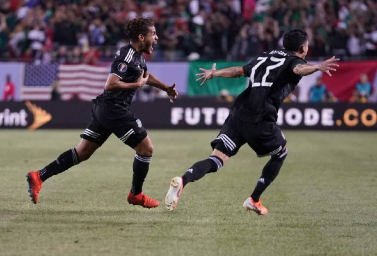 Mexico's midfielder Jonathan dos Santos (L) celebrates with teammate forward Uriel Antuna (R) after scoring against the United States during the second half of 2019 Concacaf Gold Cup final football match between USA and Mexico on July 7, 2019 at Soldier Field stadium in Chicago, Illinois. - Mexico defeated the US 1-0 (Photo by TIMOTHY A. CLARY / AFP)