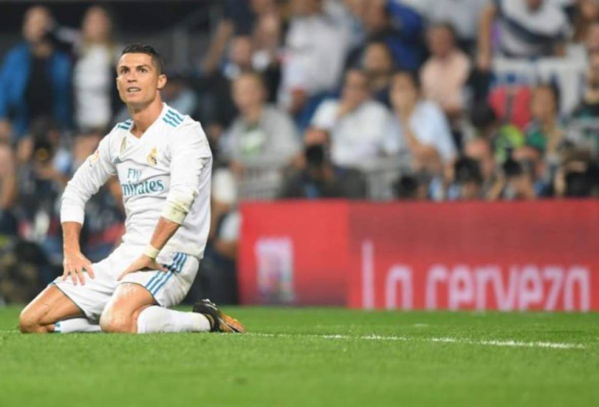 Real Madrid's forward from Portugal Cristiano Ronaldo kneels on the field during the Spanish league football match Real Madrid CF against Real Betis at the Santiago Bernabeu stadium in Madrid on September 20, 2017. / AFP PHOTO / GABRIEL BOUYS