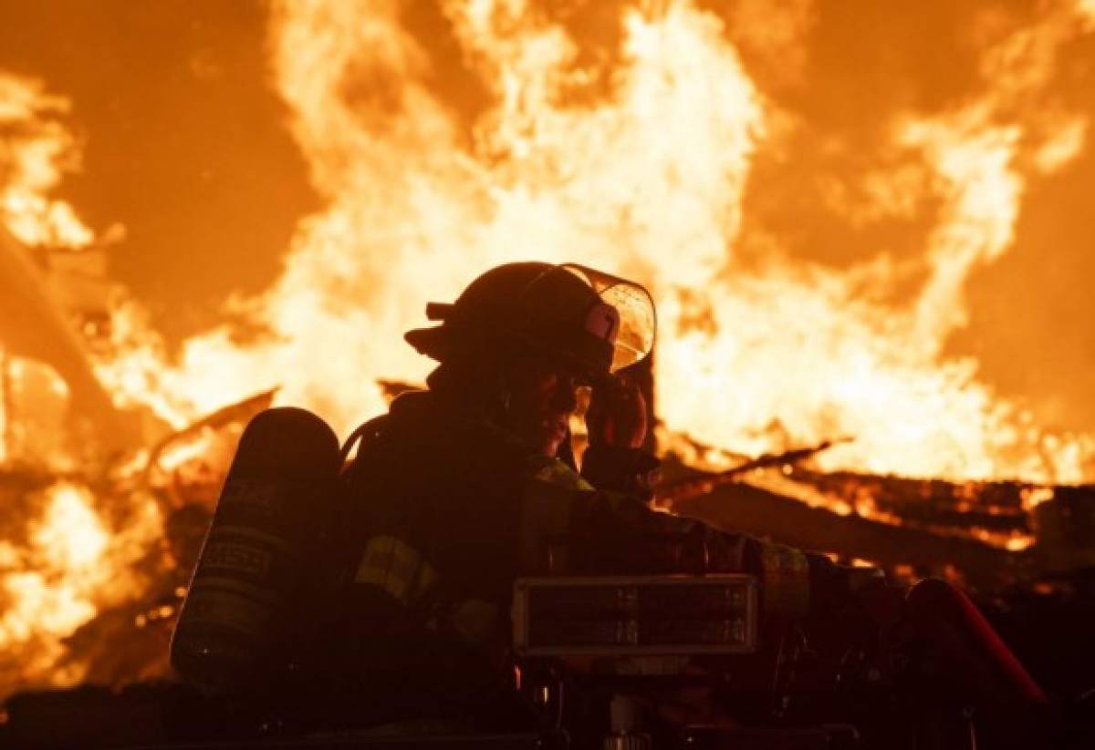 MINNEAPOLIS, MN - MAY 27: Fire fighters work to put out a fire at a factory near the Third Police Precinct on May 27, 2020 in Minneapolis, Minnesota. A number of businesses and homes were damaged as the area has become the site of an ongoing protest after the police killing of George Floyd. Four Minneapolis police officers have been fired after a video taken by a bystander was posted on social media showing Floyd's neck being pinned to the ground by an officer as he repeatedly said, 'I cant breathe'. Floyd was later pronounced dead while in police custody after being transported to Hennepin County Medical Center. Stephen Maturen/Getty Images/AFP