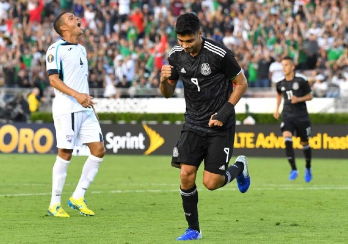 PASADENA, CA - JUNE 15: Yasmani Lopez #4 of Cuba reacts as Raul Jimenez #9 of Mexico celebrates after a goal in the first half of the game at the Rose Bowl on June 15, 2019 in Pasadena, California. Jayne Kamin-Oncea/Getty Images/AFP== FOR NEWSPAPERS, INTERNET, TELCOS & TELEVISION USE ONLY ==