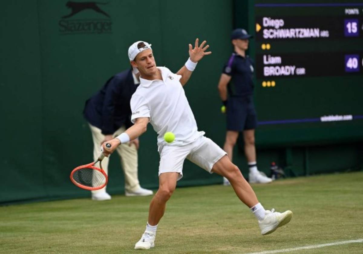 Argentina's Diego Schwartzman returns against Britain's Liam Broady during their men's singles second round match on the third day of the 2021 Wimbledon Championships at The All England Tennis Club in Wimbledon, southwest London, on June 30, 2021. (Photo by Glyn KIRK / AFP) / RESTRICTED TO EDITORIAL USE