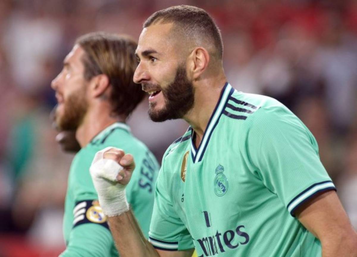 Real Madrid's French forward Karim Benzema celebrates his goal during the Spanish league football match between Sevilla FC and Real Madrid CF at the Ramon Sanchez Pizjuan stadium in Seville on September 22, 2019. (Photo by CRISTINA QUICLER / AFP)