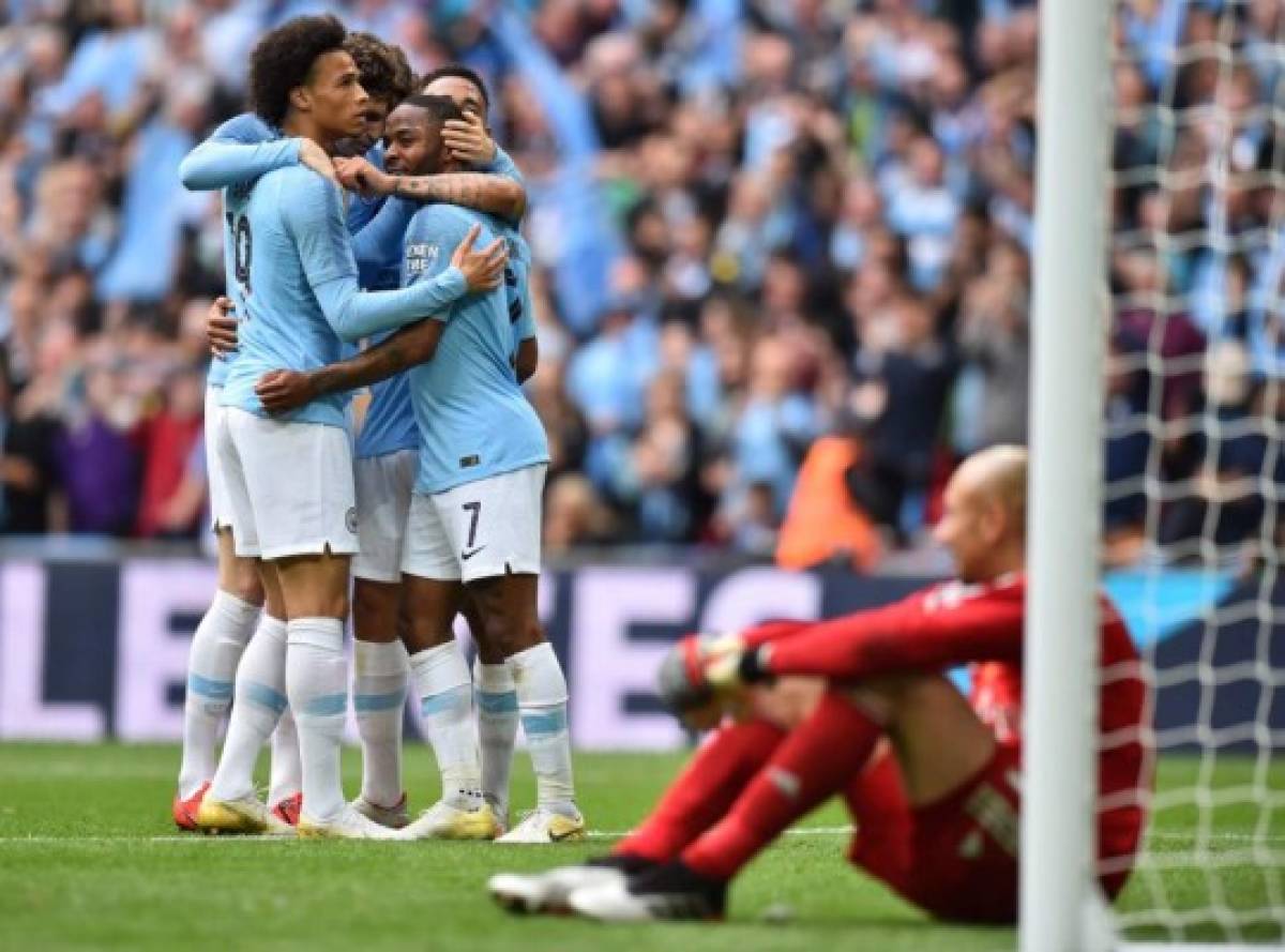 Manchester City's English midfielder Raheem Sterling (C) elebrates with teammates after he score the team's sixth goal past Watford's Brazilian goalkeeper Heurelho Gomes (R) during the English FA Cup final football match between Manchester City and Watford at Wembley Stadium in London, on May 18, 2019. (Photo by Glyn KIRK / AFP) / NOT FOR MARKETING OR ADVERTISING USE / RESTRICTED TO EDITORIAL USE