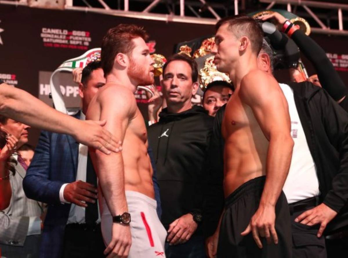 LAS VEGAS, NV - SEPTEMBER 14: Canelo Alvarez (L) and WBC/WBA middleweight champion Gennady Golovkin are held back after facing off during their official weigh-in at T-Mobile Arena on September 13, 2018 in Las Vegas, Nevada. Golovkin will defend his titles against Alvarez in a rematch on September 15 at T-Mobile Arena. Al Bello/Getty Images/AFP