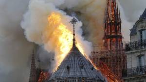 Flames and smoke are seen billowing from the roof at Notre-Dame Cathedral in Paris on April 15, 2019. - A fire broke out at the landmark Notre-Dame Cathedral in central Paris, potentially involving renovation works being carried out at the site, the fire service said.Images posted on social media showed flames and huge clouds of smoke billowing above the roof of the gothic cathedral, the most visited historic monument in Europe. (Photo by LUDOVIC MARIN / AFP)