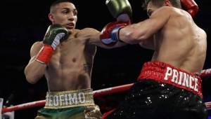 NEW YORK, NEW YORK - DECEMBER 14: Teofimo Lopez Jr punches Richard Commey during their bout for Commey's IBF lightweight title at Madison Square Garden on December 14, 2019 in New York City. Al Bello/Getty Images/AFP== FOR NEWSPAPERS, INTERNET, TELCOS & TELEVISION USE ONLY ==