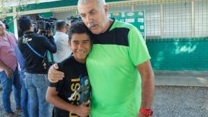 El técnico Manuel Keosseián posando con uno de los aficionados que llegaron a dar ánimos al club previo al entreno de cara al clásico ante Real España. Foto Neptalí Romero