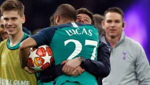 Tottenham's Brazilian forward Lucas celebrates the victory with Tottenham's Argentine coach Mauricio Pochettino at the end of the UEFA Champions League semi-final second leg football match between Ajax Amsterdam and Tottenham Hotspur at the Johan Cruyff Arena, in Amsterdam, on May 8, 2019. - Tottenham fought back from three goals down on aggregate to stun Ajax 3-2 and set up a Champions League final against Liverpool. (Photo by Adrian DENNIS / AFP)