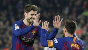 Barcelona's Argentinian forward Lionel Messi (R) celebrates with Barcelona's Spanish defender Gerard Pique after scoring a goal during the Spanish League football match between Barcelona and Real Valladolid at the Camp Nou stadium in Barcelona on February 16, 2019. (Photo by Pau Barrena / AFP)