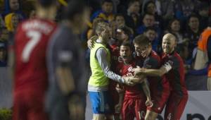 Players of Canadian Toronto celebrate after scoring against Mexico's Tigres during the Concacaf Champions League football match at the Universitario stadium in Monterrey, Mexico, March 13, 2018. / AFP PHOTO / Julio Cesar AGUILAR