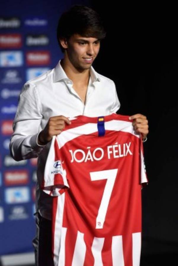 Atletico Madrid's new Portuguese midfielder Joao Felix holds his new jersey during his official presentation at the Wanda Metropolitan stadium in Madrid on July 8, 2019. (Photo by PIERRE-PHILIPPE MARCOU / AFP)