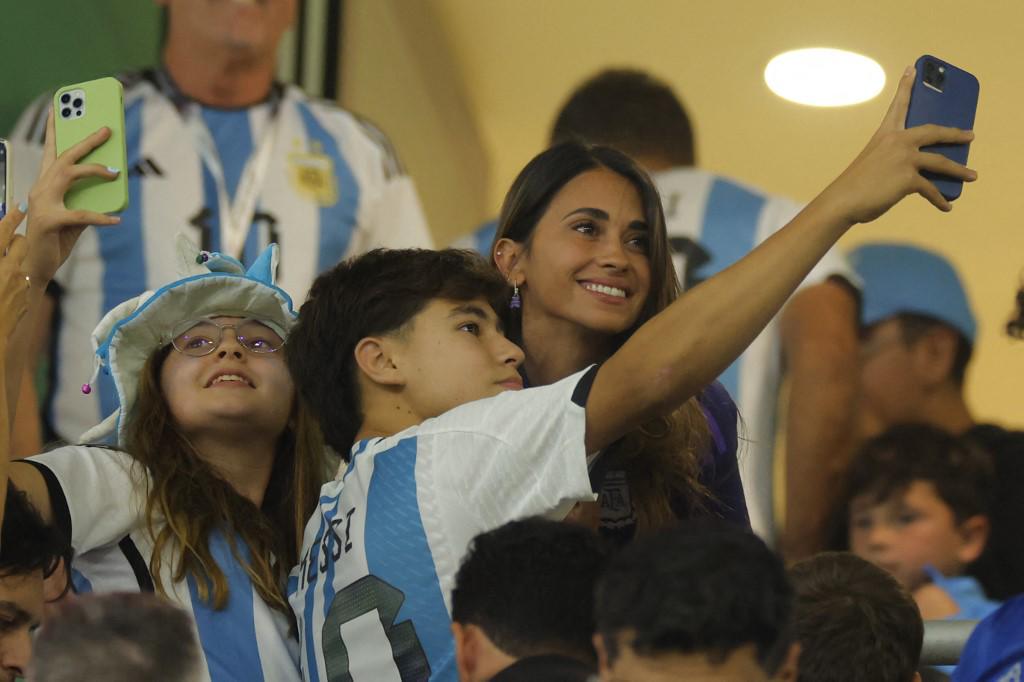Antonela Roccuzzo tomándose una fotografía junto a un aficionado argentino en Qatar.