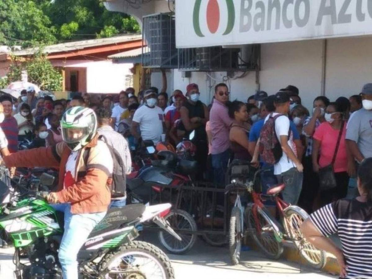 Hondureños abarrotan instituciones bancarias en medio del brote del covid-19