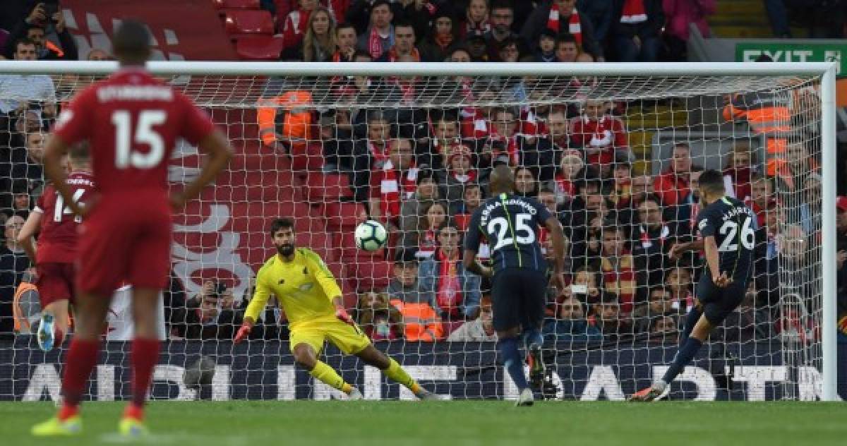 Manchester City's Algerian midfielder Riyad Mahrez (R) shoots from the penalty spot but fails to score during the English Premier League football match between Liverpool and Manchester City at Anfield in Liverpool, north west England on October 7, 2018. / AFP PHOTO / Paul ELLIS / RESTRICTED TO EDITORIAL USE. No use with unauthorized audio, video, data, fixture lists, club/league logos or 'live' services. Online in-match use limited to 120 images. An additional 40 images may be used in extra time. No video emulation. Social media in-match use limited to 120 images. An additional 40 images may be used in extra time. No use in betting publications, games or single club/league/player publications. /