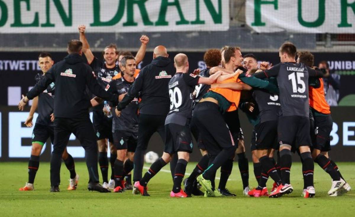 Bremen's players celebrate the second goal for Bremen during the relegation second leg play-off football match between German second division Bundesliga club FC Heidenheim and First divison Bundesliga club Werder Bremen in Heidenheim, on July 6, 2020. (Photo by KAI PFAFFENBACH / POOL / AFP) / DFL REGULATIONS PROHIBIT ANY USE OF PHOTOGRAPHS AS IMAGE SEQUENCES AND/OR QUASI-VIDEO