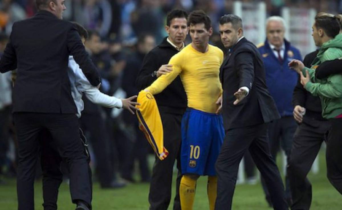 Lionel Messi al momento que regalaba su playera a un niño que llegó hasta él.