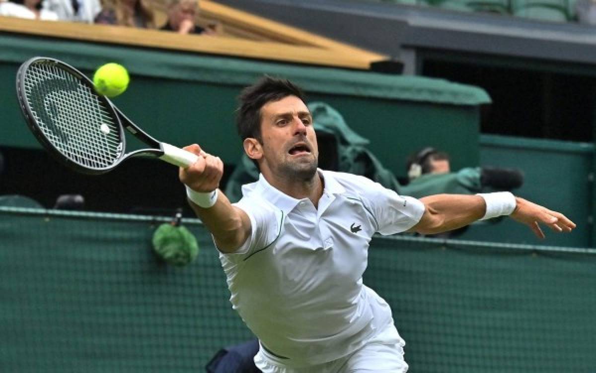 Serbia's Novak Djokovic returns against South Africa's Kevin Anderson during their men's singles second round match on the third day of the 2021 Wimbledon Championships at The All England Tennis Club in Wimbledon, southwest London, on June 30, 2021. (Photo by Ben STANSALL / AFP) / RESTRICTED TO EDITORIAL USE