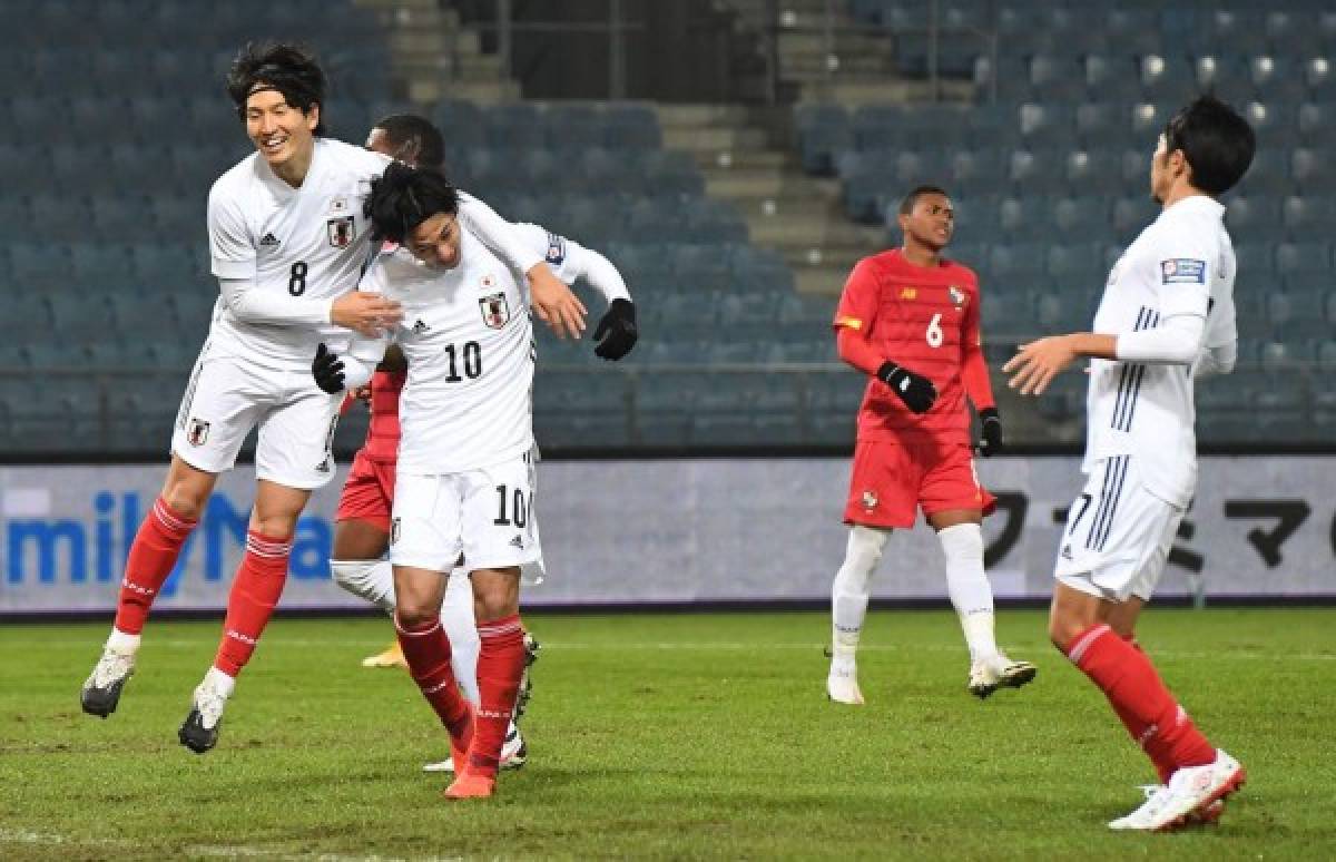 Japan's team celebrates scoring during the international friendly football match between Japan and Panama at the UPS Arena stadium in Graz, Austria, on November 13, 2020. (Photo by JOE KLAMAR / AFP)