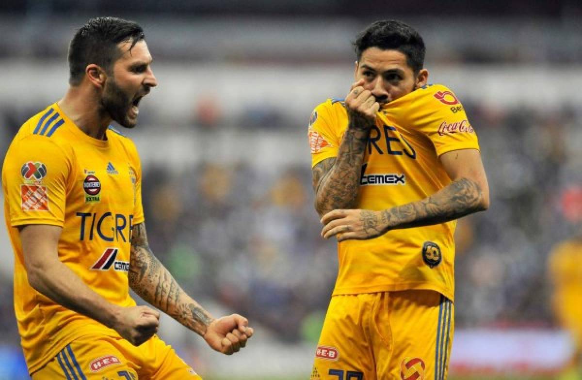 Javier Aquino (R) of Tigres celebrates with teammate Andre Gignac (L) after scoring against Cruz Azul during their Mexican Clausura tournament football match at the Azteca stadium in Mexico City on February 22, 2020. (Photo by CLAUDIO CRUZ / AFP)