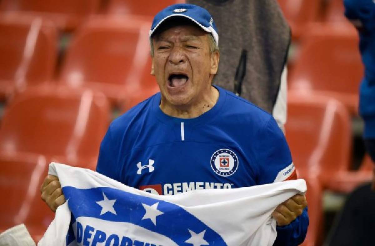 A fan of Cruz Azul celebrates his team's victory against Monterrey during the second round of semifinals of the Mexican Apertura tournament football match at the Azteca stadium on December 8, 2018, in Mexico City. (Photo by ALFREDO ESTRELLA / AFP)