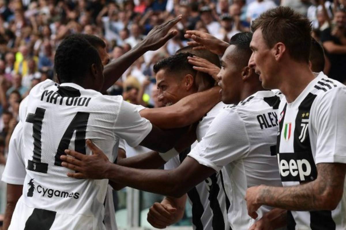 Juventus' Portuguese forward Cristiano Ronaldo (Rear C) celebrates with his teammates after he scored his first goal since he joined Juventus during the Italian Serie A football match Juventus vs Sassuolo on September 16, 2018 at the Juventus stadium in Turin. / AFP PHOTO / Miguel MEDINA