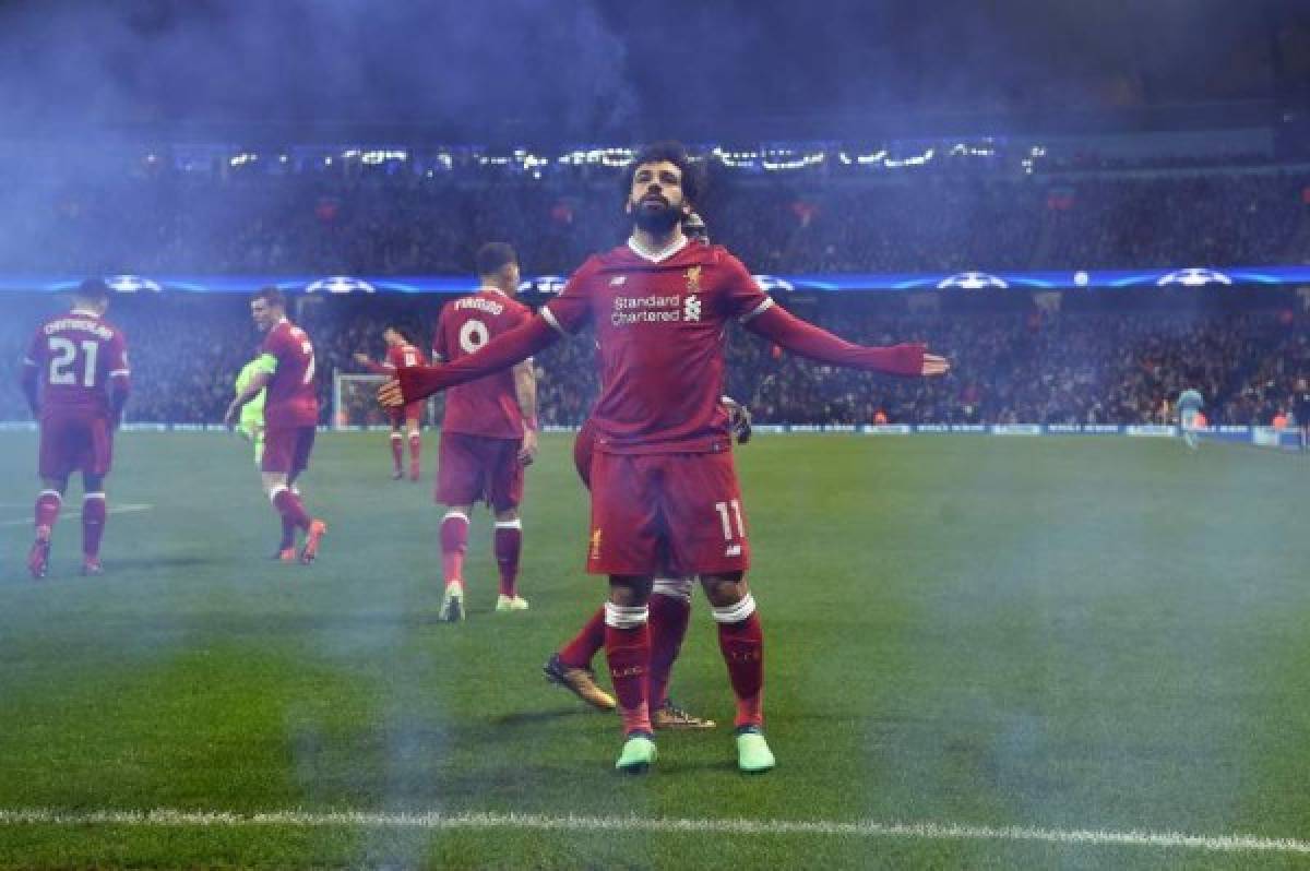 Liverpool's Egyptian midfielder Mohamed Salah celebrates scoring his team's first goal during the UEFA Champions League second leg quarter-final football match between Manchester City and Liverpool, at the Etihad Stadium in Manchester, north west England on April 10, 2018. / AFP PHOTO / Paul ELLIS