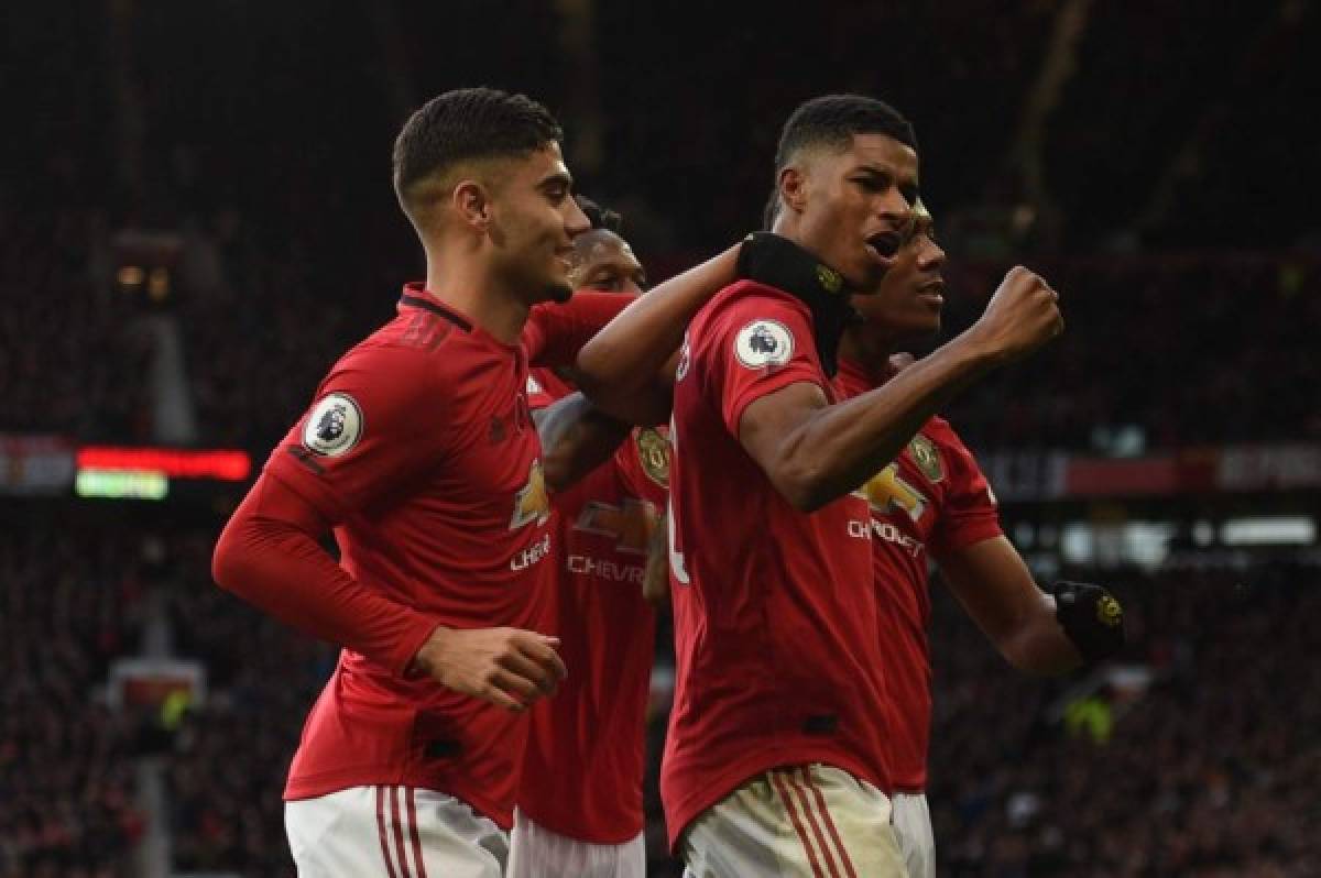 Manchester United's English striker Marcus Rashford (R) celebrates scoring their third goal during the English Premier League football match between Manchester United and Brighton and Hove Albion at Old Trafford in Manchester, north west England, on November 10, 2019. (Photo by Oli SCARFF / AFP) / RESTRICTED TO EDITORIAL USE. No use with unauthorized audio, video, data, fixture lists, club/league logos or 'live' services. Online in-match use limited to 120 images. An additional 40 images may be used in extra time. No video emulation. Social media in-match use limited to 120 images. An additional 40 images may be used in extra time. No use in betting publications, games or single club/league/player publications. /