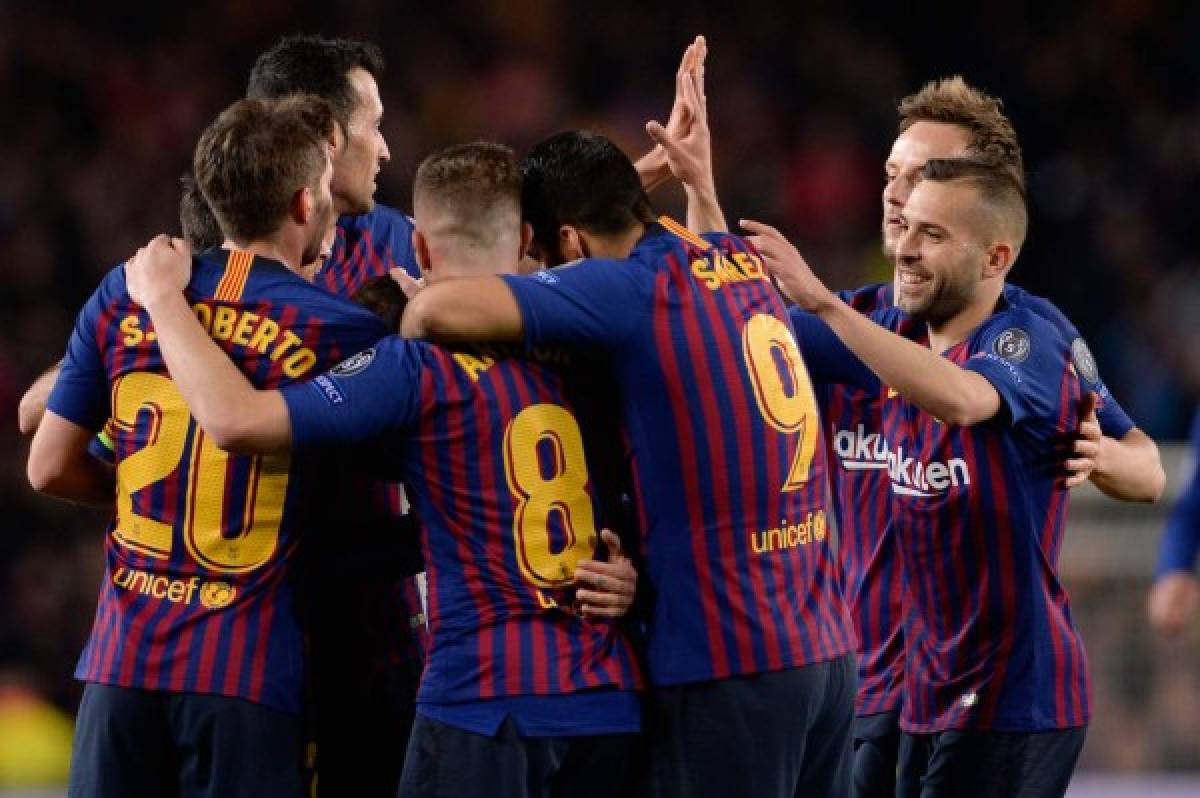 Barcelona players celebrate their third goal during the UEFA Champions League quarter-final second leg football match between Barcelona and Manchester United at the Camp Nou stadium in Barcelona on April 16, 2019. (Photo by PAU BARRENA / AFP)