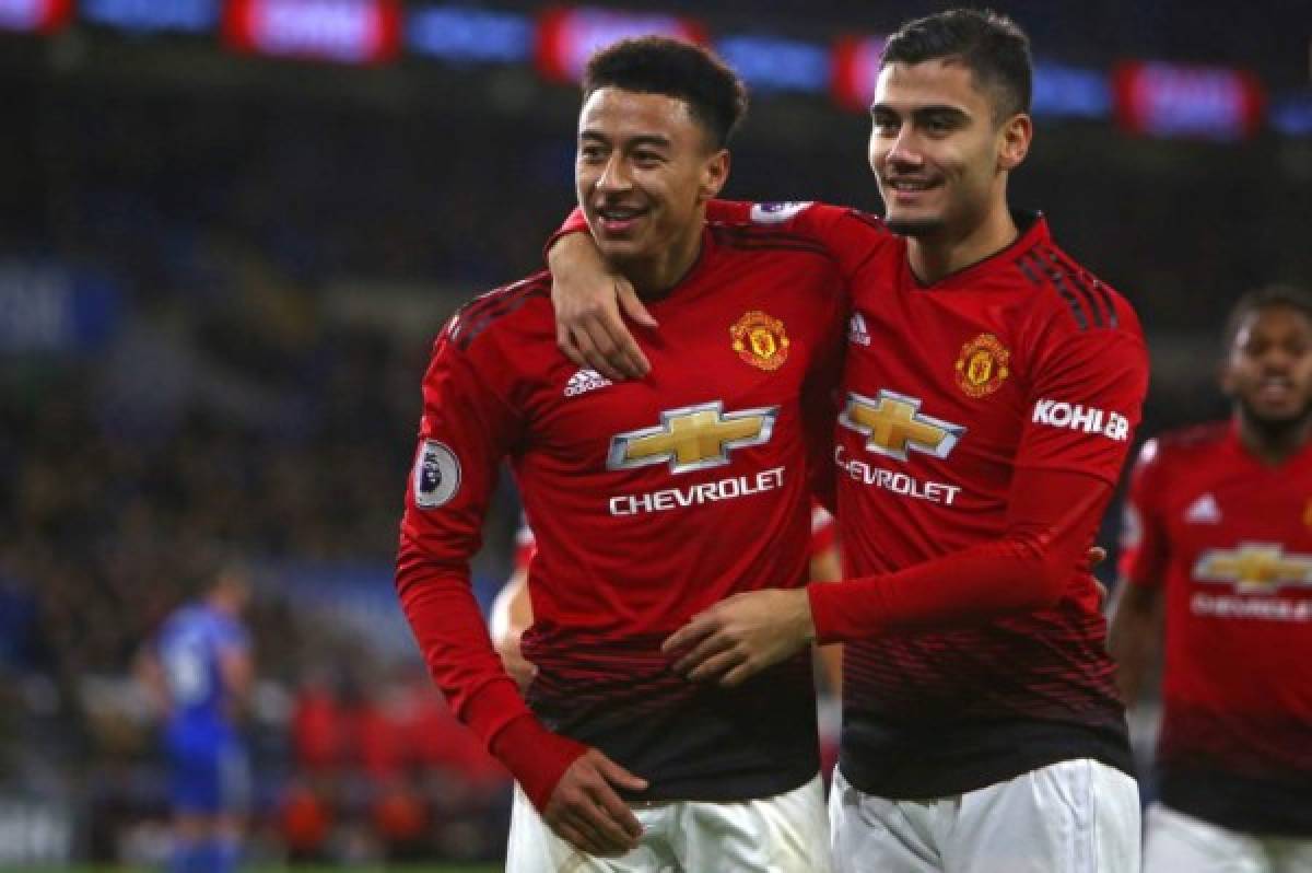 Manchester United's English midfielder Jesse Lingard (L) celebrates with Manchester United's Belgian-born Brazilian midfielder Andreas Pereira after scoring their fifth goal during the English Premier League football match between between Cardiff City and Manchester United at Cardiff City Stadium in Cardiff, south Wales on December 22, 2018. - Manchester United won the game 5-1. (Photo by Geoff CADDICK / AFP) / RESTRICTED TO EDITORIAL USE. No use with unauthorized audio, video, data, fixture lists, club/league logos or 'live' services. Online in-match use limited to 120 images. An additional 40 images may be used in extra time. No video emulation. Social media in-match use limited to 120 images. An additional 40 images may be used in extra time. No use in betting publications, games or single club/league/player publications. /