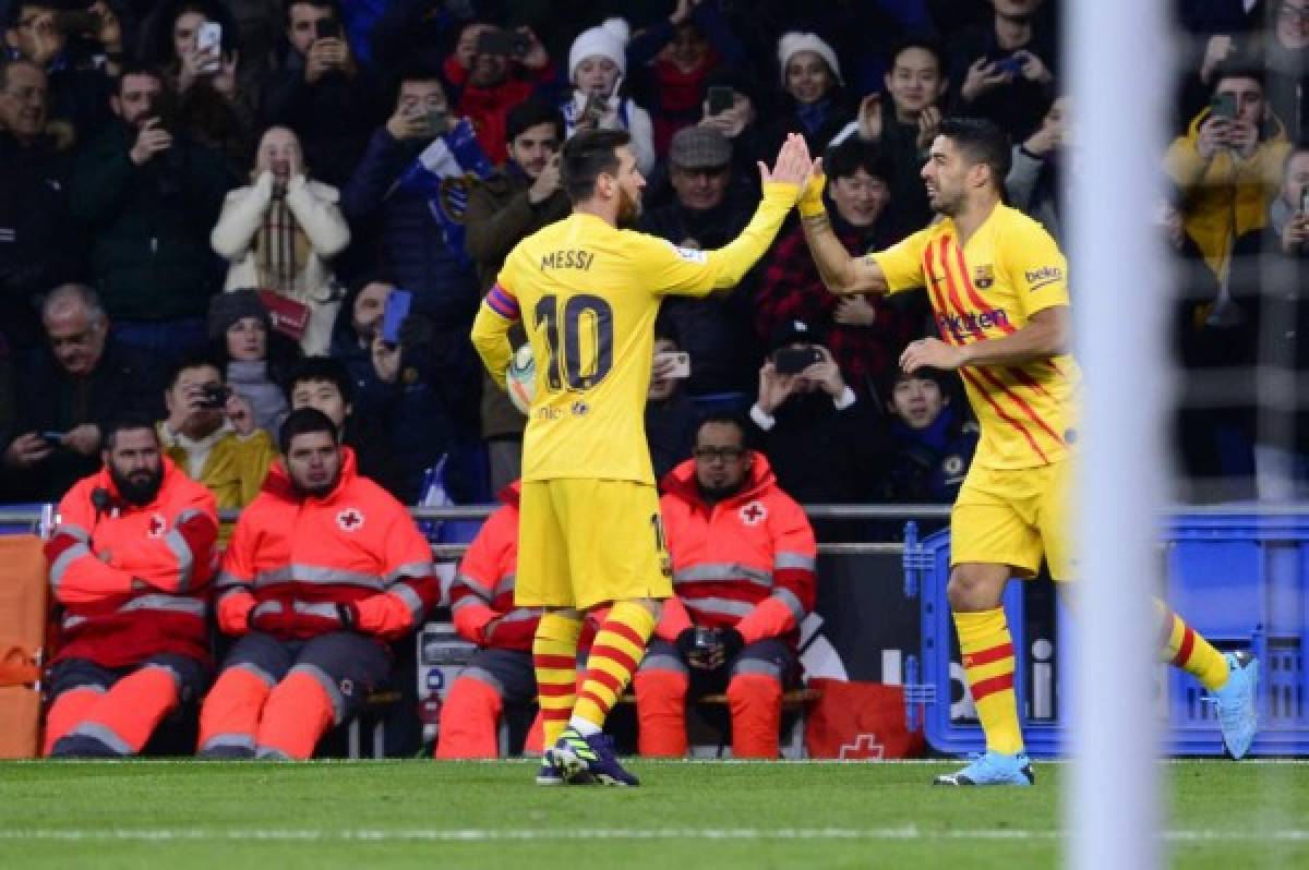 Barcelona's Argentine forward Lionel Messi (L) celebrates Barcelona's Uruguayan forward Luis Suarez's goal during the Spanish league football match between RCD Espanyol and FC Barcelona at the RCDE Stadium in Cornella de Llobregat on January 4, 2020. (Photo by PAU BARRENA / AFP)