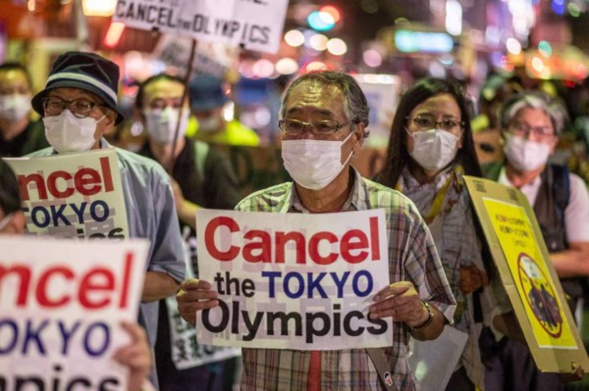 A group of anti-Olympic activists march to the offices of the Tokyo Organising Committee of the Olympic and Paralympic Games in Tokyo in July 16, 2021. (Photo by Philip FONG / AFP)