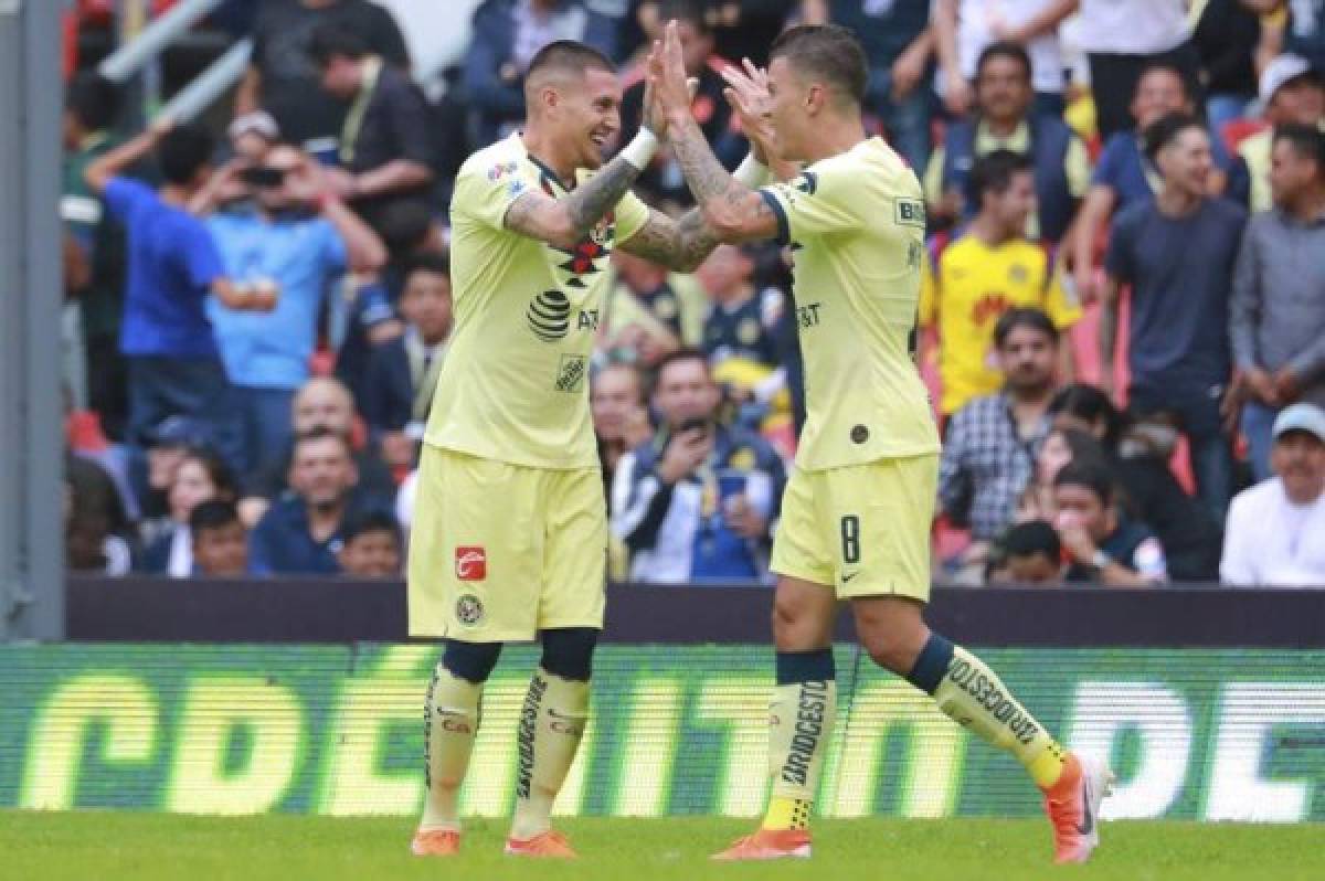 Mateus Uribe (R) of America celebrates his goal with his teammate Nicolas Castillo during the Mexican Apertura 2019 tournament football match against Monterrey at the Azteca stadium in Mexico City, on July 20, 2019. (Photo by Marcos Dominguez / AFP)