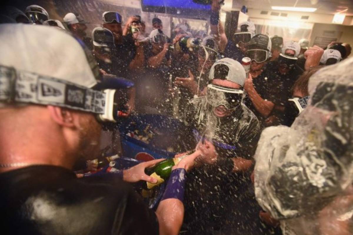 CHICAGO, IL - OCTOBER 02: The Colorado Rockies celebrate in the clubhouse after defeating the Chicago Cubs 2-1 in thirteen innings to win the National League Wild Card Game at Wrigley Field on October 2, 2018 in Chicago, Illinois. Stacy Revere/Getty Images/AFP