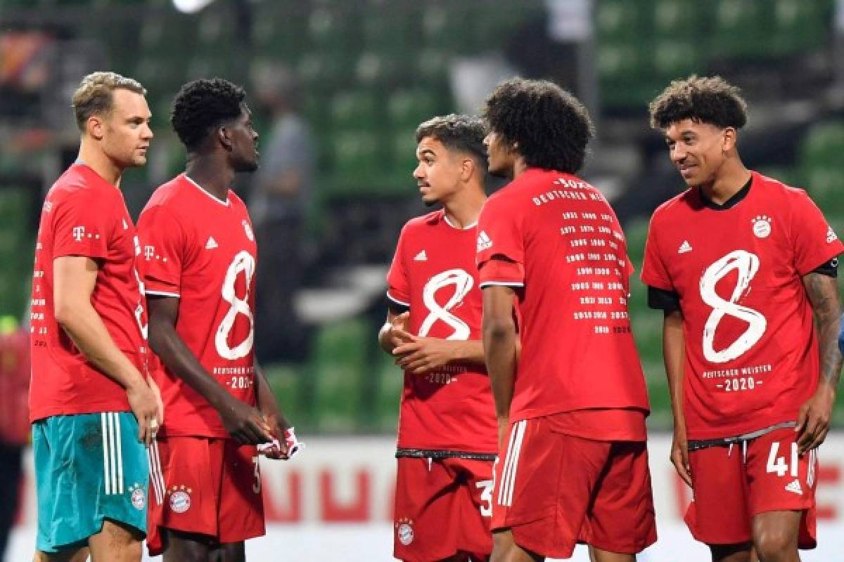 Bayern Munich's players celebrate wearing their shirts for the eight title in a row after the German first division Bundesliga football match SV Werder Bremen v FC Bayern Munich on June 16, 2020 in Bremen, northern Germany. - Bayern Munich were crowned German Bundesliga champions for the eight year in a row on June 16, 2020 after their away win against Bremen. (Photo by Martin MEISSNER / POOL / AFP) / DFL REGULATIONS PROHIBIT ANY USE OF PHOTOGRAPHS AS IMAGE SEQUENCES AND/OR QUASI-VIDEO