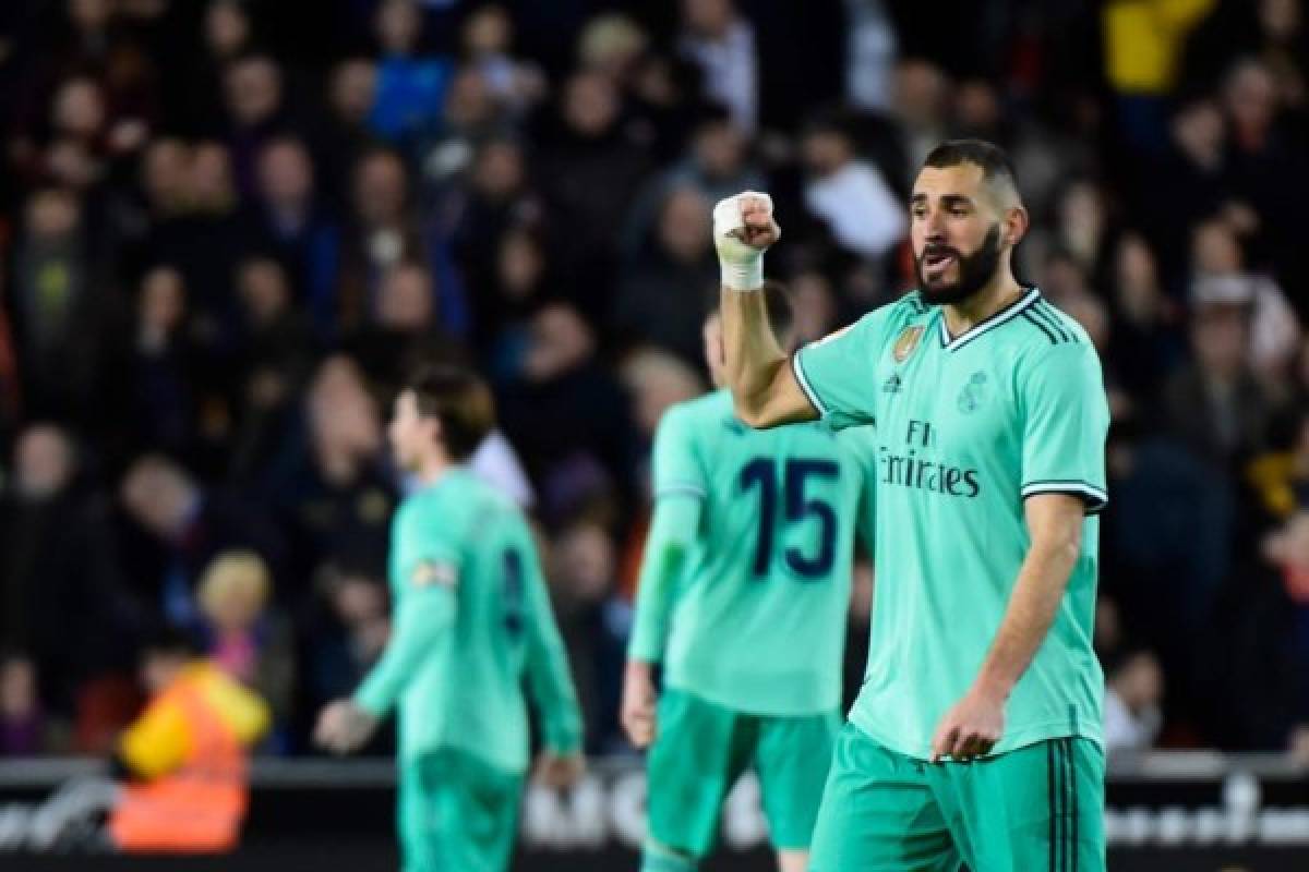 Real Madrid's French forward Karim Benzema celebrates after scoring a goal during the Spanish League football match between Valencia CF and Real Madrid, at the Mestalla stadium in Valencia, on December 15, 2019. (Photo by JOSE JORDAN / AFP)