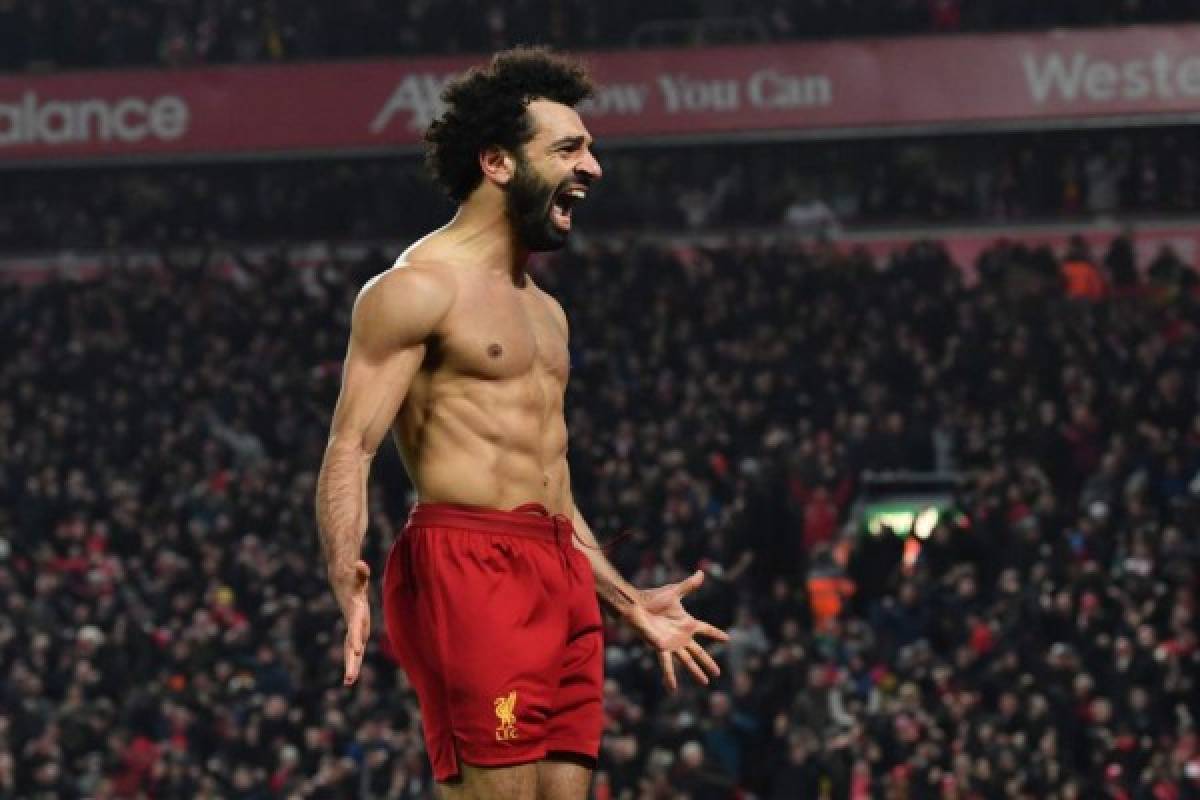 Liverpool's Egyptian midfielder Mohamed Salah celebrates scoring their second goal during the English Premier League football match between Liverpool and Manchester United at Anfield stadium in Liverpool, north west England on January 19, 2020. (Photo by Paul ELLIS / AFP) / RESTRICTED TO EDITORIAL USE. No use with unauthorized audio, video, data, fixture lists, club/league logos or 'live' services. Online in-match use limited to 120 images. An additional 40 images may be used in extra time. No video emulation. Social media in-match use limited to 120 images. An additional 40 images may be used in extra time. No use in betting publications, games or single club/league/player publications. /