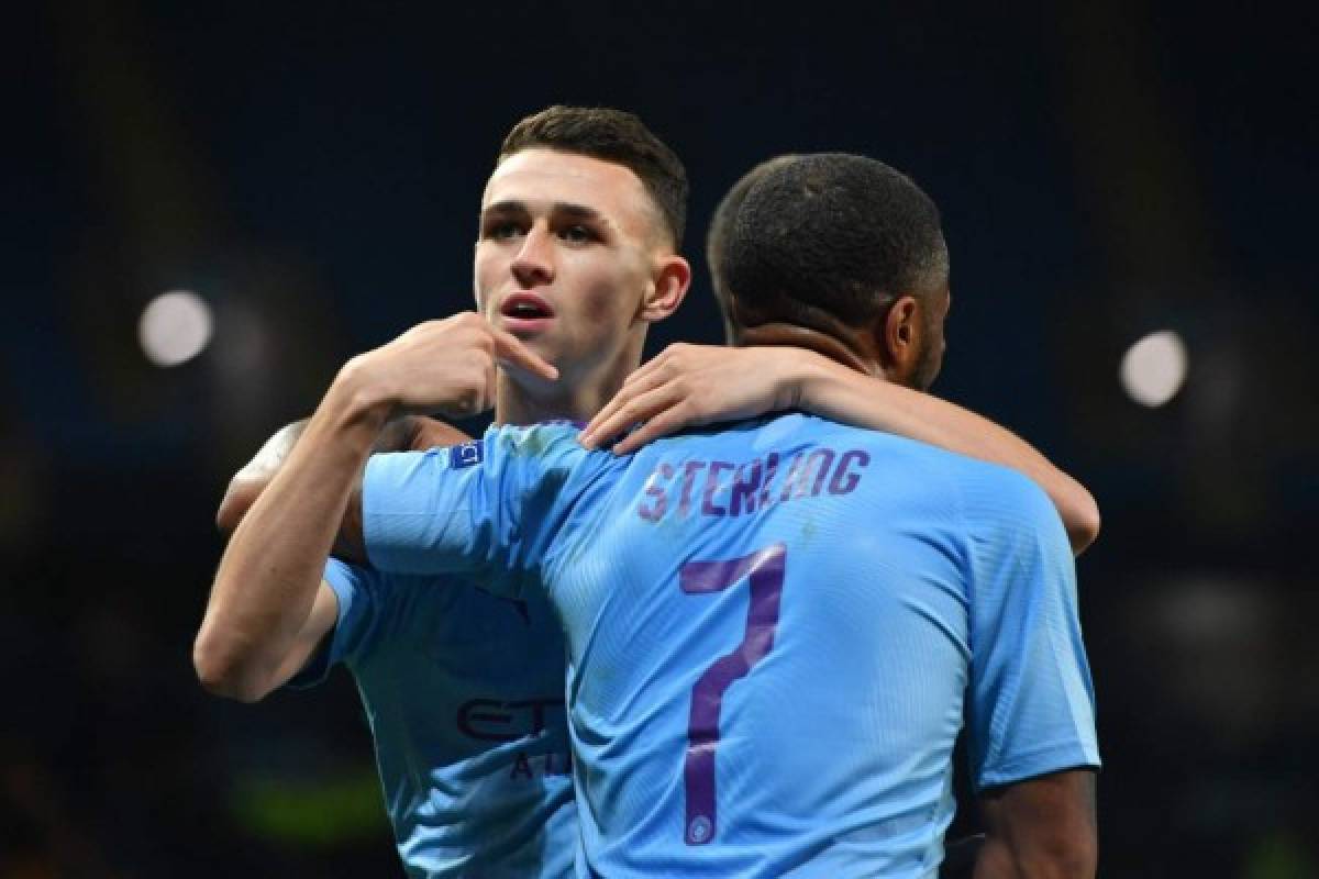 Manchester City's English midfielder Phil Foden celebrates with Manchester City's English midfielder Raheem Sterling after scoring their second goal during the UEFA Champions League Group C football match between Manchester City and Dinamo Zagreb at the Etihad Stadium in Manchester, north west England on October 1, 2019. - Manchester City won the game 2-0. (Photo by Anthony Devlin / AFP)