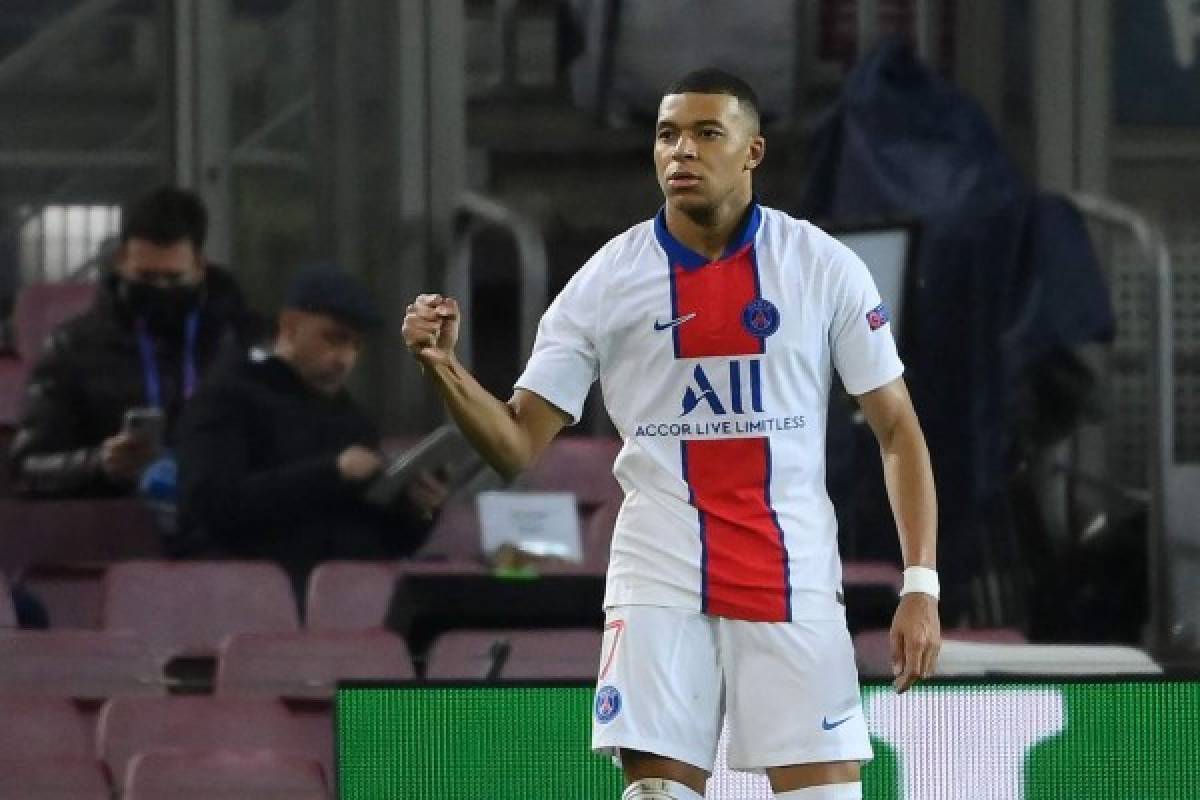 Paris Saint-Germain's French forward Kylian Mbappe celebrates after scoring a goal during the UEFA Champions League round of 16 first leg football match between FC Barcelona and Paris Saint-Germain FC at the Camp Nou stadium in Barcelona on February 16, 2021. (Photo by LLUIS GENE / AFP)