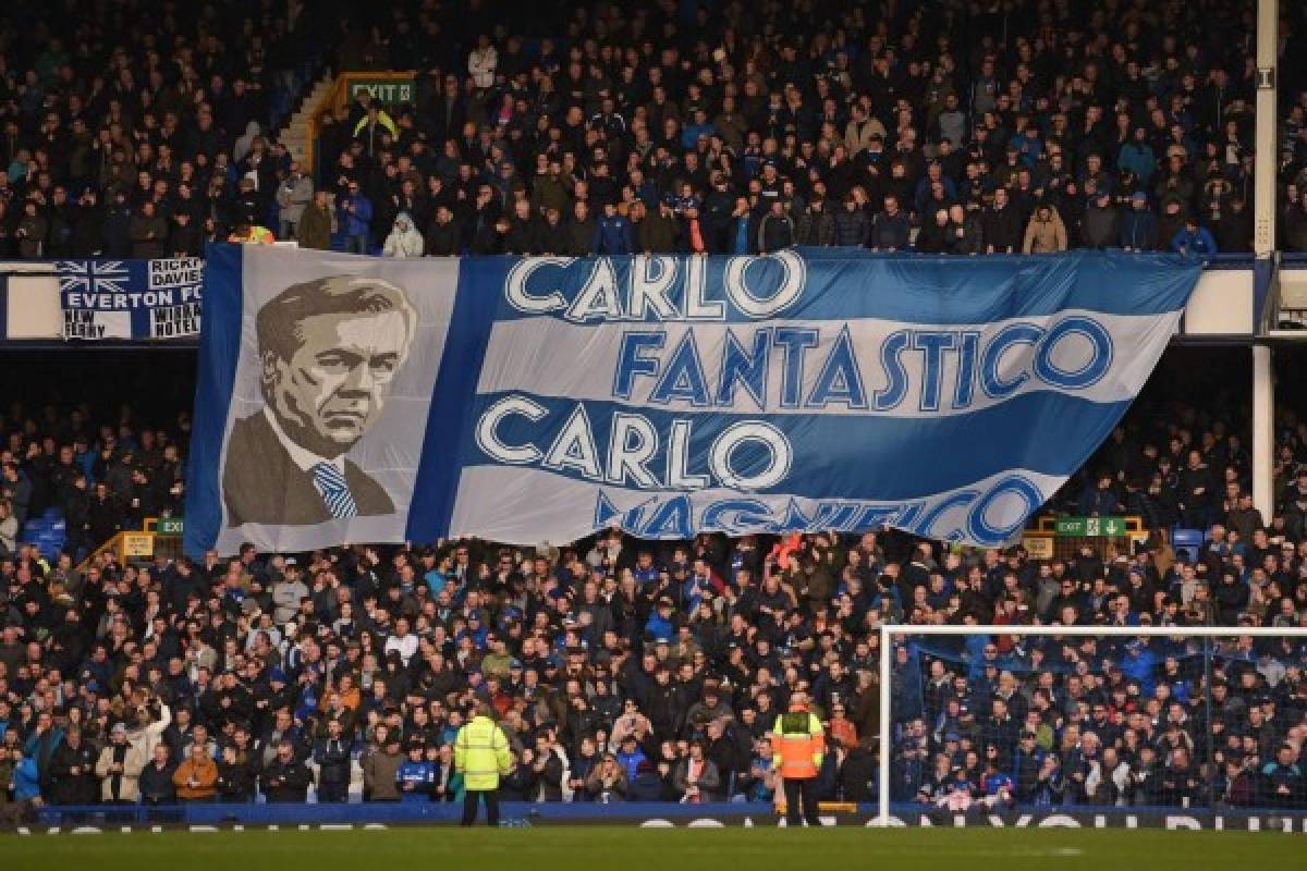TOPSHOT - Fans unfurl a huge flag of Everton's Italian head coach Carlo Ancelotti in the crowd ahead of the English Premier League football match between Everton and Crystal Palace at Goodison Park in Liverpool, north west England on February 8, 2020. (Photo by Oli SCARFF / AFP) / RESTRICTED TO EDITORIAL USE. No use with unauthorized audio, video, data, fixture lists, club/league logos or 'live' services. Online in-match use limited to 120 images. An additional 40 images may be used in extra time. No video emulation. Social media in-match use limited to 120 images. An additional 40 images may be used in extra time. No use in betting publications, games or single club/league/player publications. /