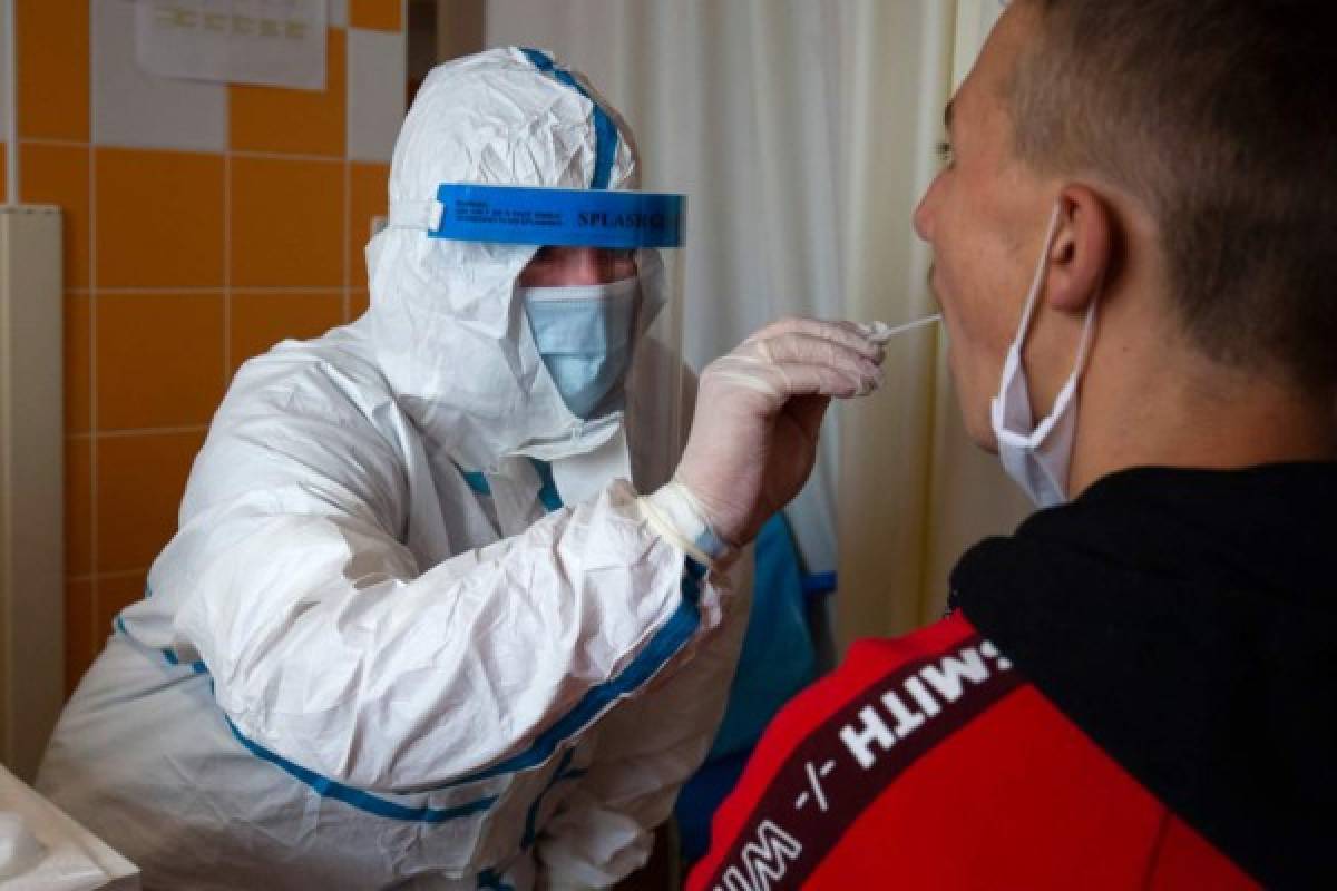 A nurse takes a sample from a man's throat for the coronavirus testat one of the sampling points of the Pecs University, in the Pulmonary Medicine Department of St. Rafael Hospital in Zalaegerszeg on May 13, 2020 as part of the national, representative examination of the four medical universities. - More than 17000 Hungarians were invited to the program at random. They represent the society of the country by age, gender, and region. (Photo by GYORGY VARGA / POOL / AFP)