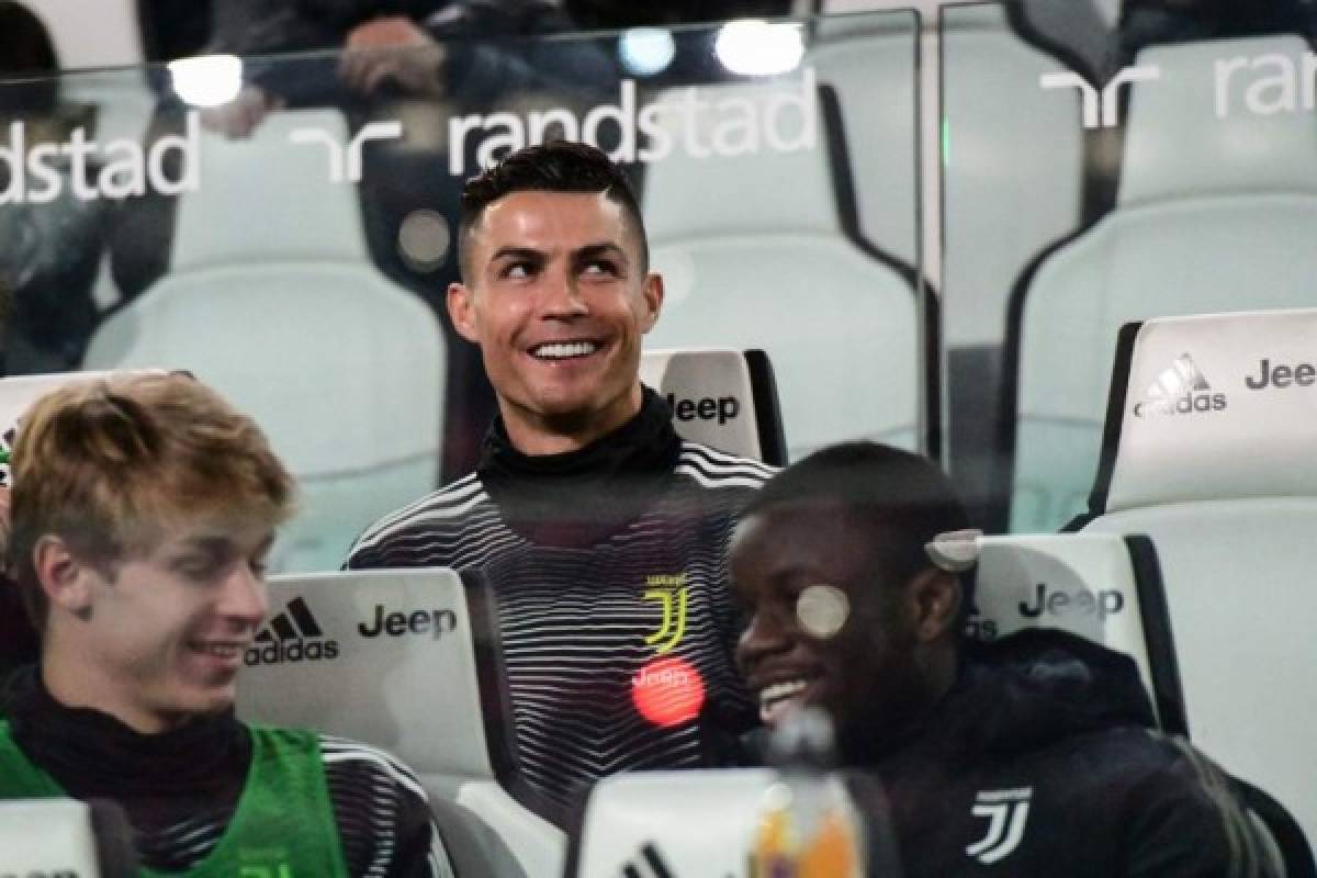 Juventus' Portuguese forward Cristiano Ronaldo smiles as he sits in the substitutes area prior to the Italian Serie A football match Juventus vs Udinese on March 8, 2019 at the Juventus Allianz stadium in Turin. (Photo by Miguel MEDINA / AFP)