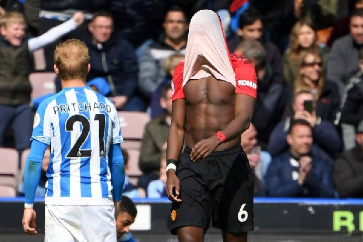 Manchester United's French midfielder Paul Pogba reacts on the pitch after the English Premier League football match between Huddersfield Town and Manchester United at the John Smith's stadium in Huddersfield, northern England on May 5, 2019. - Manchester United fail to qualify for the Champions League after 1-1 draw at Huddersfield. (Photo by Paul ELLIS / AFP) / RESTRICTED TO EDITORIAL USE. No use with unauthorized audio, video, data, fixture lists, club/league logos or 'live' services. Online in-match use limited to 120 images. An additional 40 images may be used in extra time. No video emulation. Social media in-match use limited to 120 images. An additional 40 images may be used in extra time. No use in betting publications, games or single club/league/player publications. /