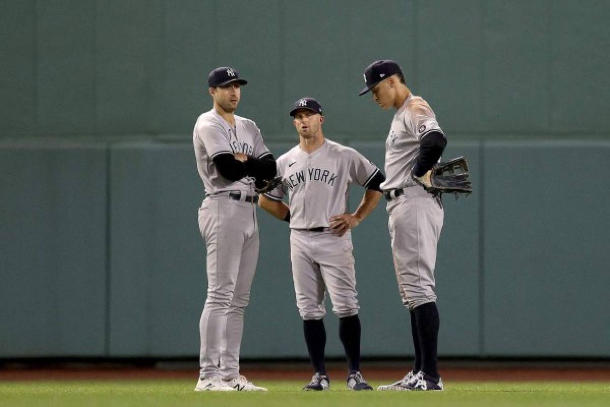 BOSTON, MASSACHUSETTS - OCTOBER 05: Joey Gallo #13, Brett Gardner #11 and Aaron Judge #99 of the New York Yankees stand in the outfield during a pitching change against the Boston Red Sox during the seventh inning of the American League Wild Card game at Fenway Park on October 05, 2021 in Boston, Massachusetts. Maddie Meyer/Getty Images/AFP (Photo by Maddie Meyer / GETTY IMAGES NORTH AMERICA / Getty Images via AFP)