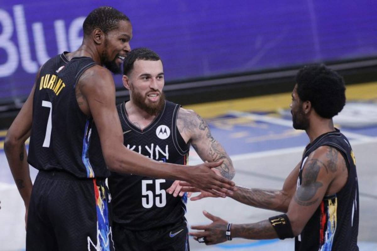 NEW YORK, NEW YORK - MAY 16: Kevin Durant #7, Mike James #55, and Kyrie Irving #11 of the Brooklyn Nets high-five during the first half against the Cleveland Cavaliers at Barclays Center on May 16, 2021 in the Brooklyn borough of New York City. NOTE TO USER: User expressly acknowledges and agrees that, by downloading and or using this photograph, User is consenting to the terms and conditions of the Getty Images License Agreement. Sarah Stier/Getty Images/AFP (Photo by Sarah Stier / GETTY IMAGES NORTH AMERICA / Getty Images via AFP)