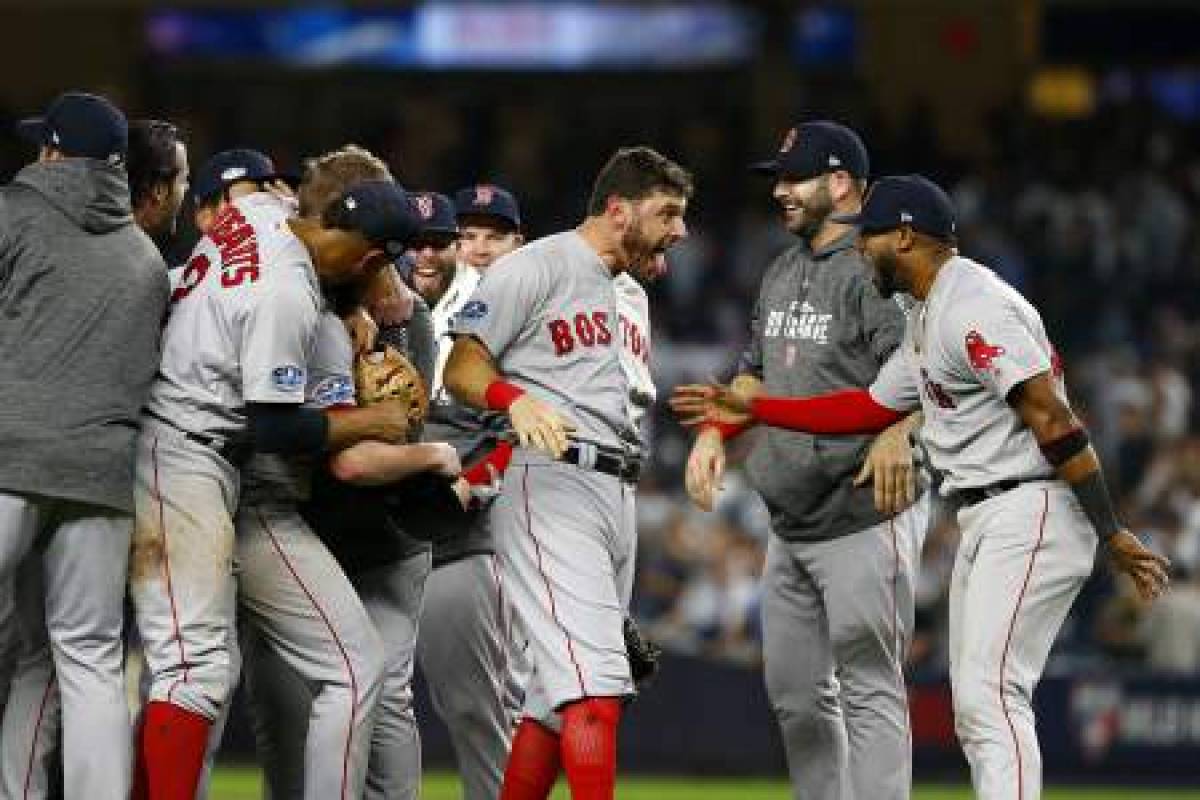 NEW YORK, NEW YORK - OCTOBER 09: Eduardo Nunez #36 and Ian Kinsler #5 of the Boston Red Sox celebrate after defeating the New York Yankees in Game Four to win the American League Division Series at Yankee Stadium on October 09, 2018 in the Bronx borough of New York City. Mike Stobe/Getty Images/AFP