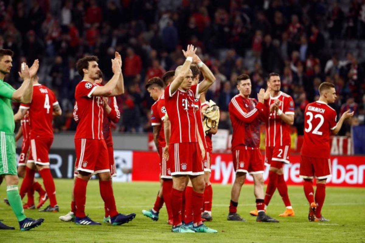 Bayern Munich's players celebrate at the end of the UEFA Champions League quarter-final second leg football match between FC Bayern Munich and Sevilla FC on April 11, 2018 in Munich, southern Germany.Bayern Munich reached the Champions League semi-finals for the seventh time in nine seasons as Wednesday's goalless draw at home to Sevilla sent the German side through 2-1 on aggregate. / AFP PHOTO / DPA AND AFP PHOTO / Odd ANDERSEN / Germany OUT