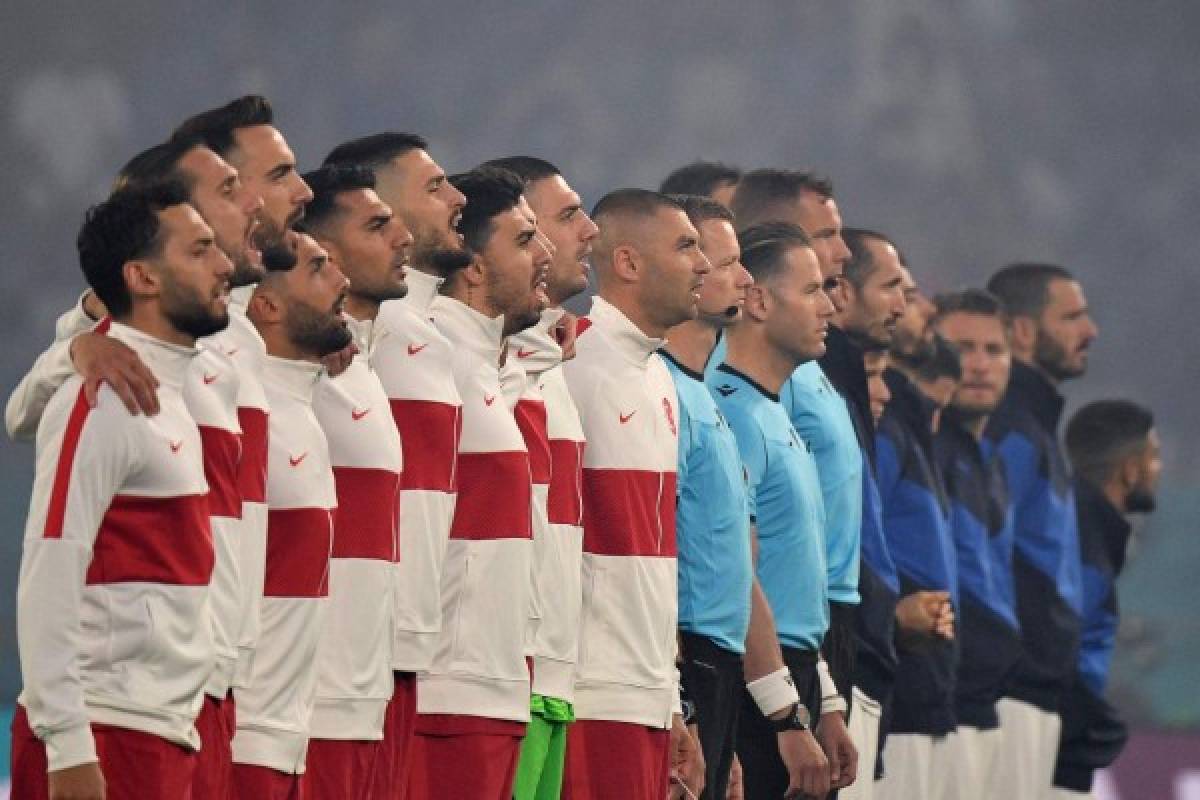Turkey's players sing their national anthem before the UEFA EURO 2020 Group A football match between Turkey and Italy at the Olympic Stadium in Rome on June 11, 2021. (Photo by Filippo MONTEFORTE / POOL / AFP)