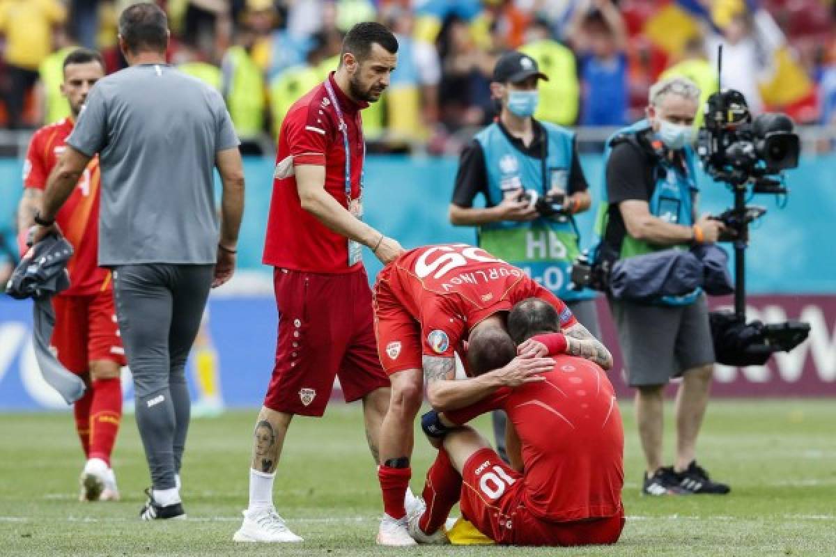 North Macedonia's players react after losing the UEFA EURO 2020 Group C football match between Ukraine and North Macedonia at the National Arena in Bucharest on June 17, 2021. (Photo by Robert Ghement / POOL / AFP)